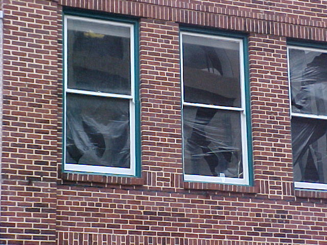 Three windows in a row damaged from hail.